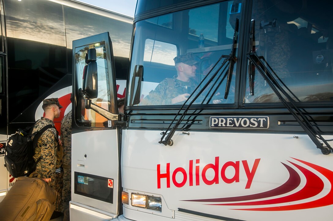 U.S. Marines and Sailors with the 26th Marine Expeditionary Unit (MEU), board buses during the unit's departure from Camp Lejeune, N.C., to embark on a deployment at sea Feb. 6, 2018. The MEU Marines and Sailors are deploying to support maritime security operations, crisis response and theater security cooperation, while also providing a forward expeditionary naval presence in Europe and the Middle East.