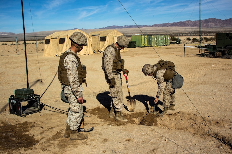 Marines with Marine Wing Communication Squadron 38 dig trenches for wires at Camp Wilson aboard the Marine Corps Air Ground Combat Center, Twentynine Palms, Calif., January 22, 2018, as a part of Integrated Training Exercise 2-18. The purpose of ITX is to create a challenging, realistic training environment that produces a combat-ready forces capable of operating as an integrated MAGTF. (Photo provided by courtesy asset)