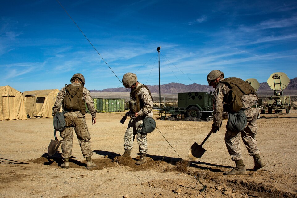 Marines with Marine Wing Communication Squadron 38 dig trenches for wires at Camp Wilson aboard the Marine Corps Air Ground Combat Center, Twentynine Palms, Calif., January 22, 2018, as a part of Integrated Training Exercise 2-18. The purpose of ITX is to create a challenging, realistic training environment that produces a combat-ready forces capable of operating as an integrated MAGTF.(Photo provided by courtesy asset)
