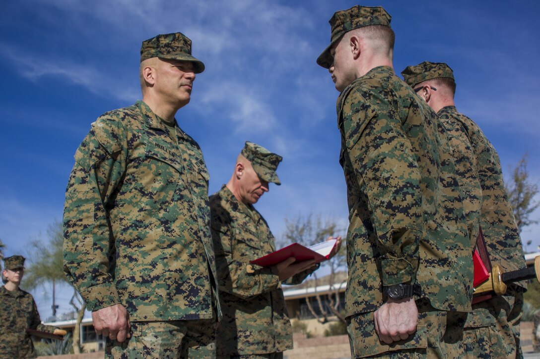 Major General William F. Mullen III, base commanding general, Marine Air Ground Task Force Training Command, Marine Corps Air Ground Combat Center presents a Marine with an award in recognition of his exemplary service aboard MCAGCC, Jan. 16, 2018. The Marines were being awarded the Navy and Marine Corps Achievement Medal for above-and-beyond service both in and out of uniform. (U.S. Marine Corps photo by Pfc. Rachel K. Porter)