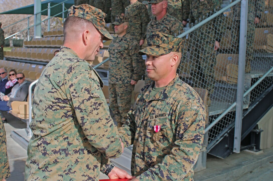 Sgt. Maj. Earl D. Budd, off going battalion sergeant major, 3rd Battalion, 11th Marine Regiment, receives a meritorious service medal for his outstanding service with 3/11 during the post and relief ceremony at the commanding general’s lawn aboard the Marine Corps Air Ground Combat Center Twentynine Palms, Calif., Jan. 18, 2018. Budd relinquished his post as battalion Sergeant Major to Sgt. Maj. Travis L. Debarr, incoming sergeant major, 3/11. (U.S. Marine Corps Photo by LCpl. Jennessa Davey)
