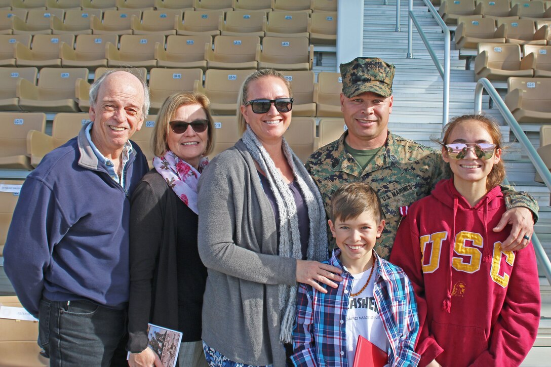 Sgt. Maj. Earl D. Budd, off going battalion Sergeant Major, 3rd Battalion 11th Marine Regiment, takes a photo with his family after the post and relief ceremony at the commanding general’s lawn aboard the Marine Corps Air Ground Combat Center Twentynine Palms, Calif., Jan. 18, 2018. Budd relinquished his post as battalion Sergeant Major to Sgt. Maj. Travis L. Debarr. (U.S. Marine Corps Photo by LCpl. Jennessa Davey)
