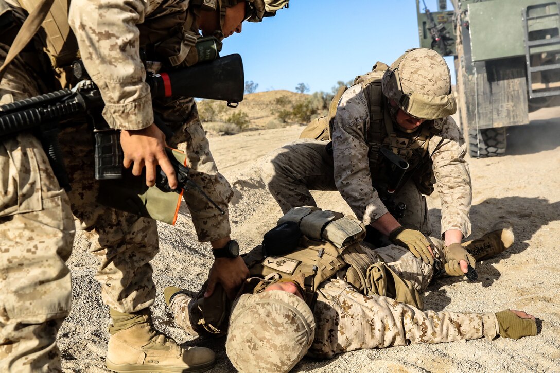 A Marine with Combat Logistics Battalion 3 applies a tourniquet to a simulated casualty during Integrated Training Exercise 2-18 aboard Marine Air Ground Combat Center, Twentynine Palms, Calif., Jan. 24, 2018.  The purpose of ITX is to create a challenging, realistic training environment that produces combat-ready forces capable of operating as an integrated MAGTF. (U.S. Marine Corps Photo by LCpl Conner Downey)