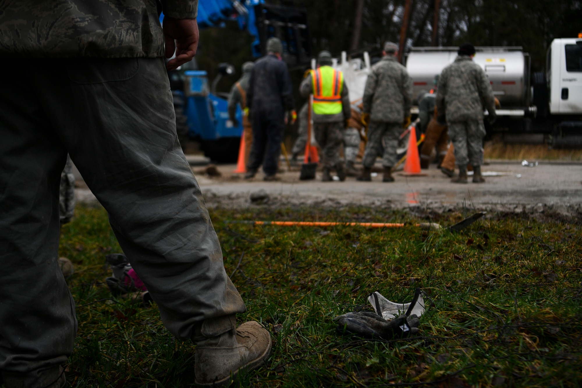 A U.S. Airman watches as his counterparts fill a hole in the runway during a Rapid Airfield Damage Repair training exercise on Ramstein Air Base, Germany, Jan. 25, 2018. Airmen would tag in and out of the exercise to rest after mixing flowable fill cement. (U.S. Air Force photo by Senior Airman Devin M. Rumbaugh)