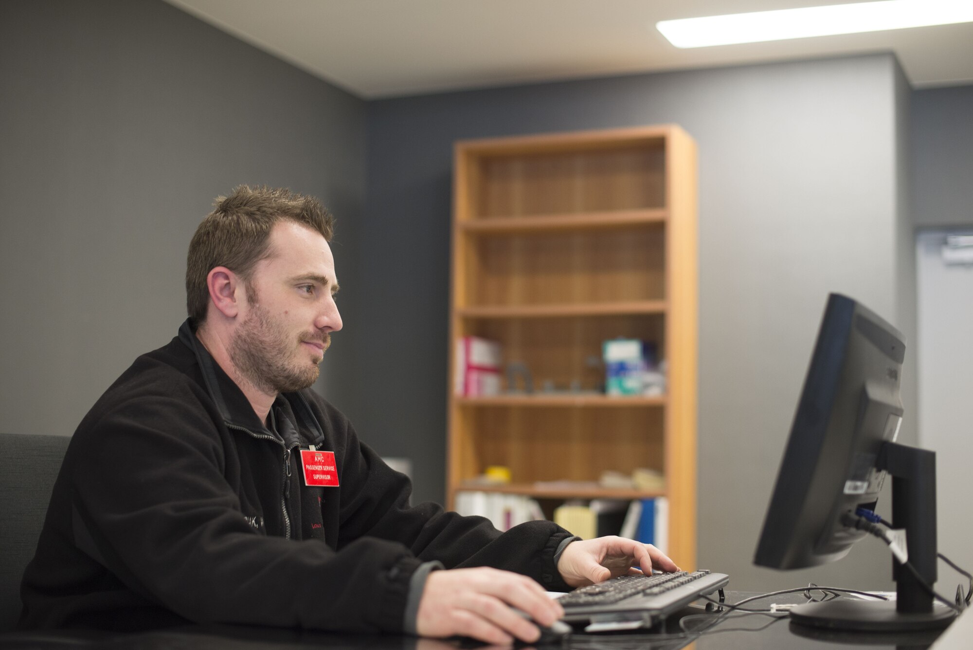 Passenger service supervisor on computer