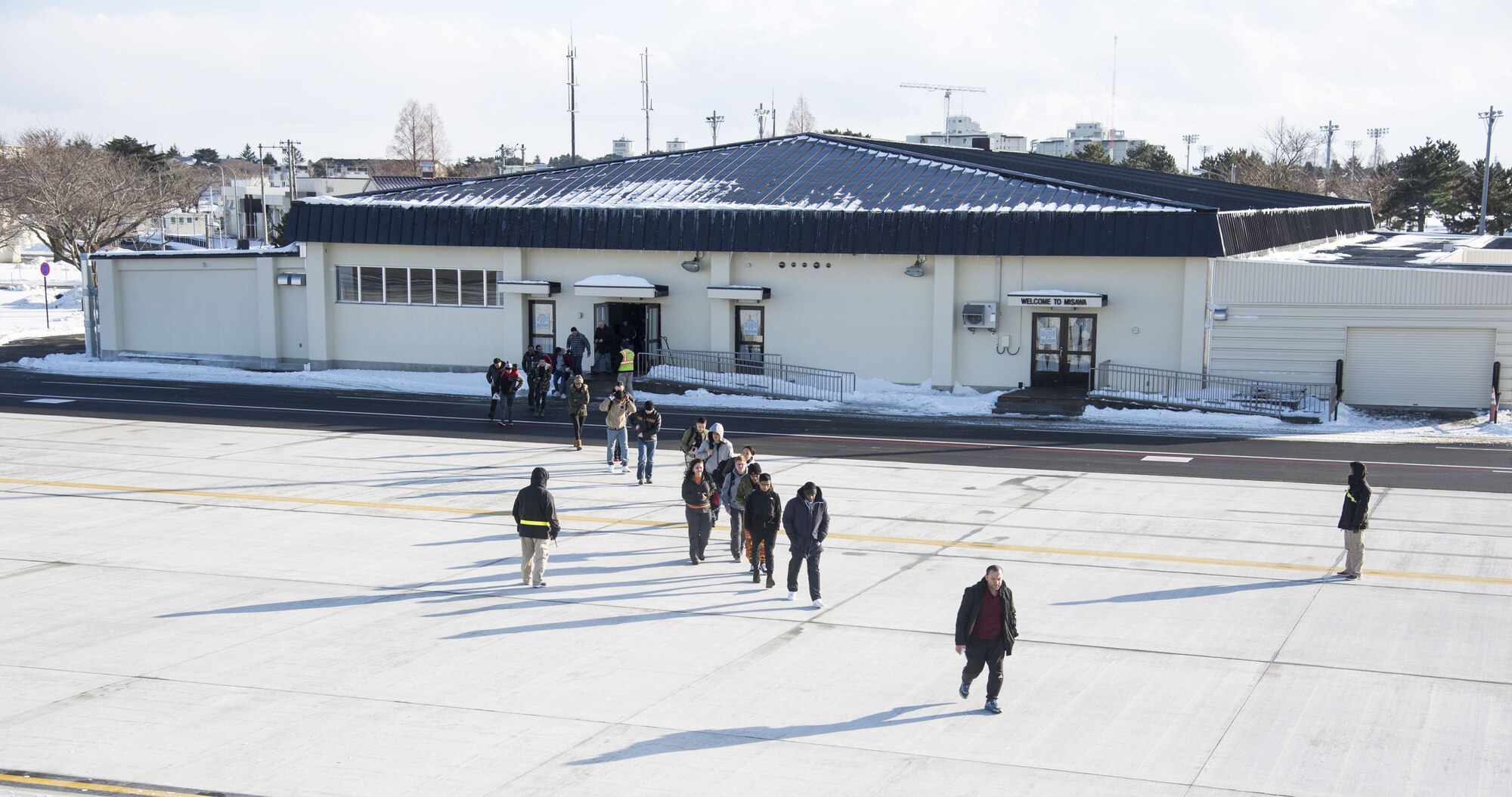 Passengers walking on flight line