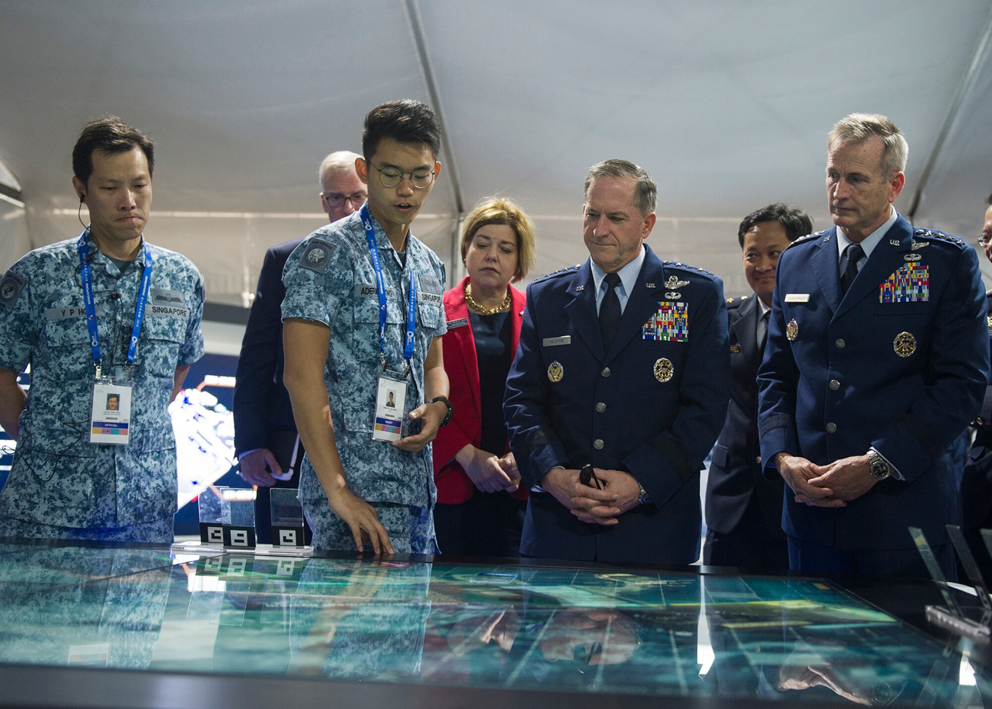 Gen. David L. Goldfein, U.S. Air Force chief of staff, Gen. Terrence J. O’Shaughnessy, Pacific Air Forces commander, and Heidi H. Grant, Deputy Under Secretary of the Air Force, International Affairs, receive a demonstration of a display during the 2018 Singapore International Airshow, Changi Exhibition Centre, Singapore, Feb. 6, 2018.