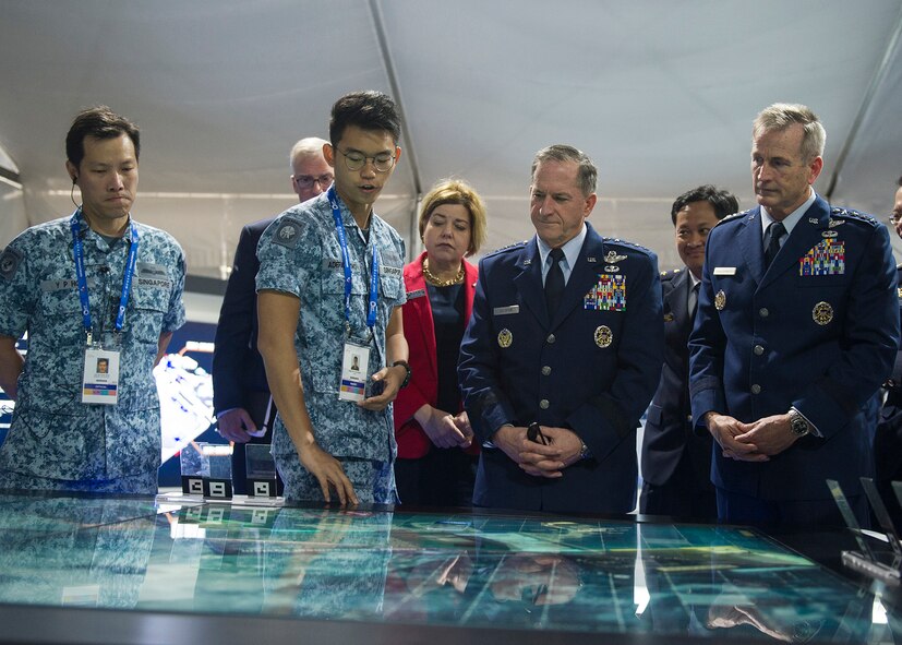 Gen. David L. Goldfein, U.S. Air Force chief of staff, Gen. Terrence J. O’Shaughnessy, Pacific Air Forces commander, and Heidi H. Grant, Deputy Under Secretary of the Air Force, International Affairs, receive a demonstration of a display during the 2018 Singapore International Airshow, Changi Exhibition Centre, Singapore, Feb. 6, 2018.