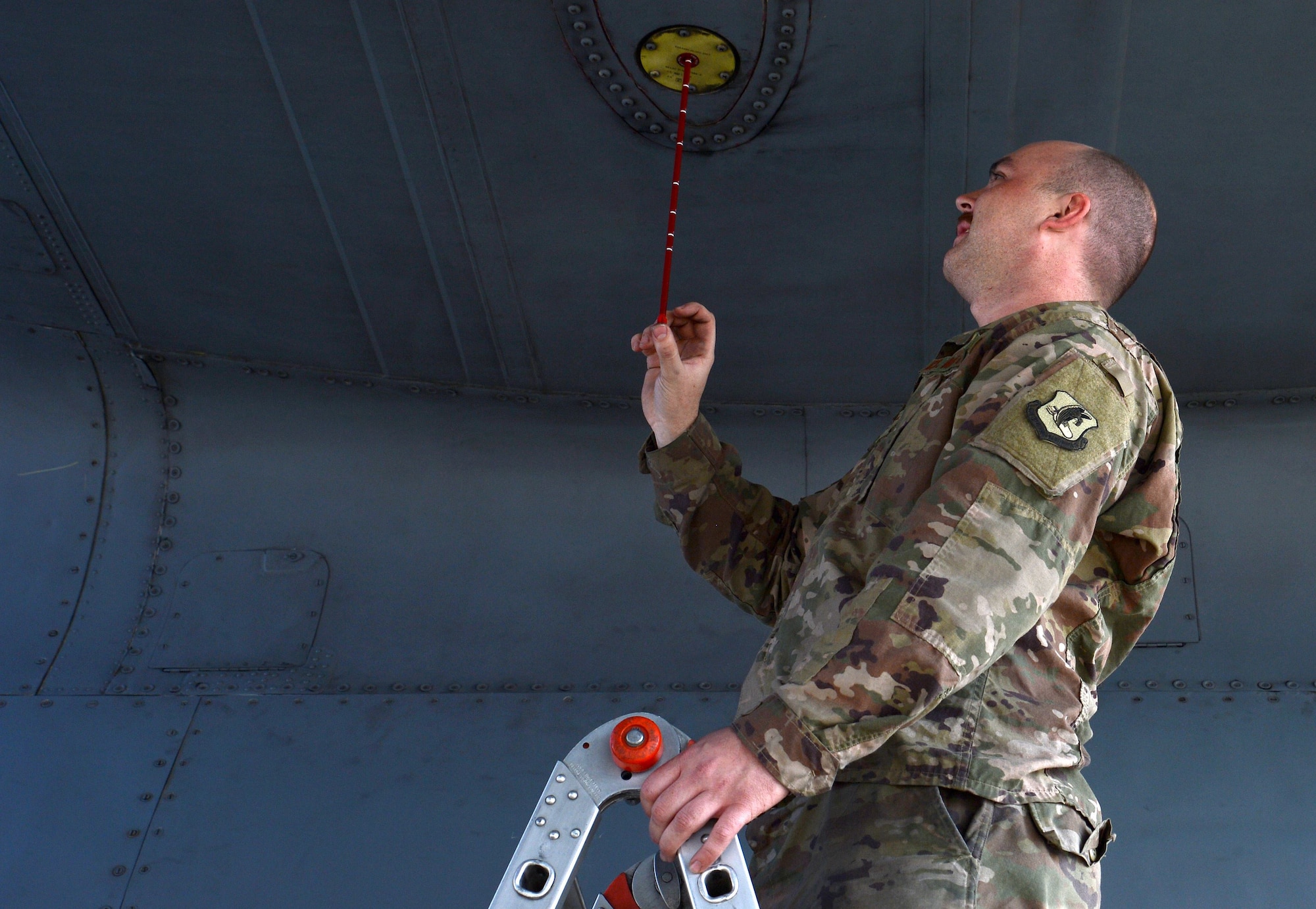 Airman 1st Class Nicholas Foydl, 455th Expeditionary Aircraft Maintenance Squadron EC-130H Compass Call crew chief, checks the oil of an EC-130H Feb. 2, 2018 at Bagram Airfield, Afghanistan.