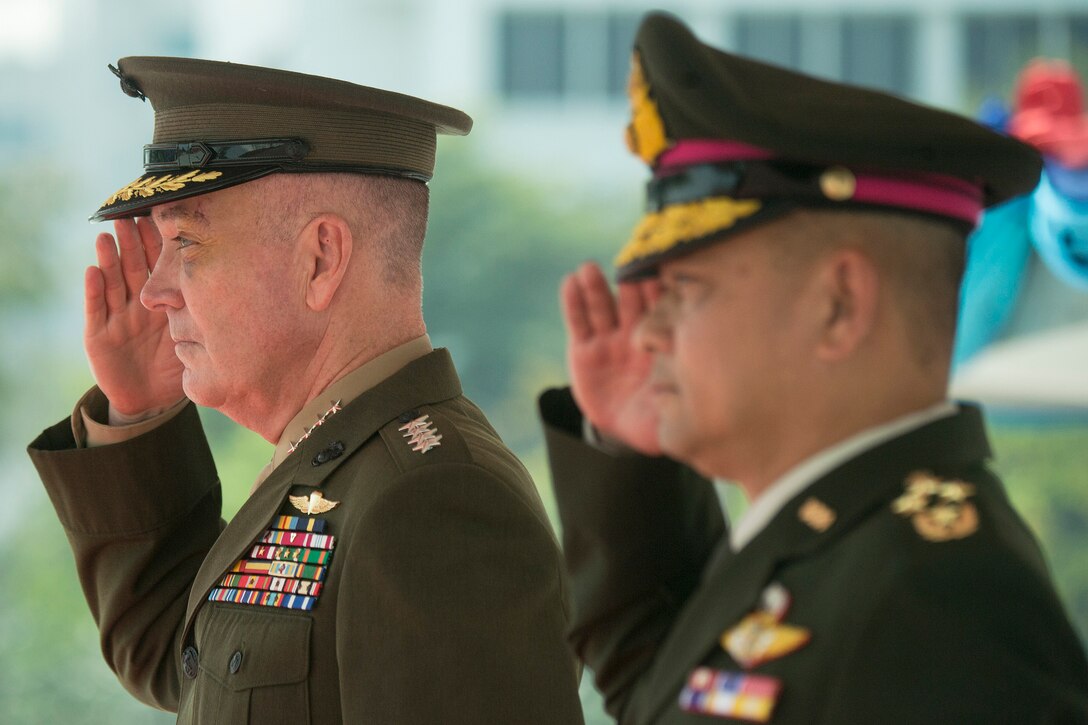 U.S. and Thai military leaders render honors during a ceremony in Bangkok.