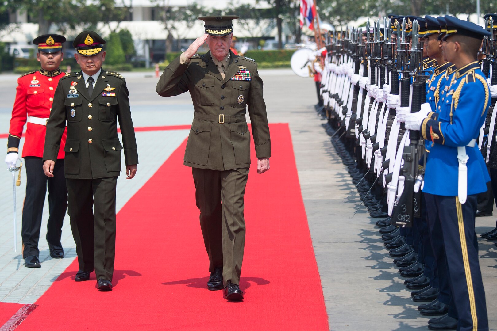 U.S, and Thai military leaders walk by an honor guard in Bangkok.