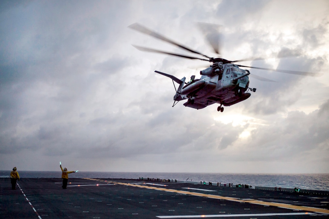 A CH-53E Super Stallion helicopter takes off from the flight deck of the amphibious assault ship USS Bonhomme Richard.