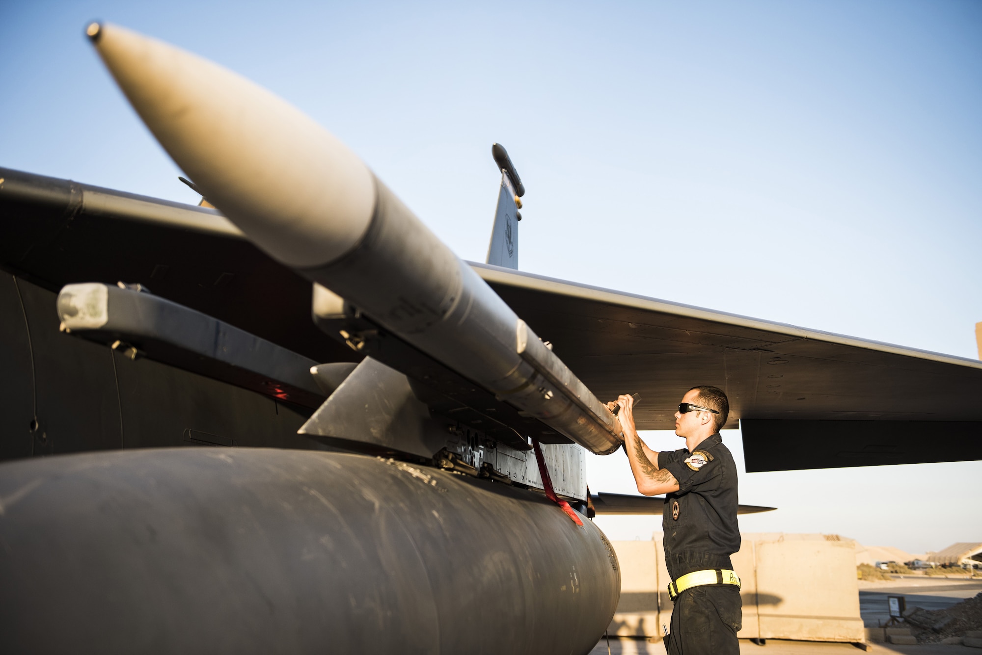 Senior Airman Hunter Barto, assigned 332d Expeditionary Maintenance Squadron, checks the placement of munitions beneath the wing of an F-15E Strike Eagle November 10, 2017 in Southwest Asia. 332d EMXS Airmen are responsible for all aspects of maintenance and upkeep on Strike Eagles assigned to the 332d Air Expeditionary Wing, which has been the primary provider of air power in support of Operation Inherent Resolve. (U.S. Air Force photo by Staff Sgt. Joshua Kleinholz)