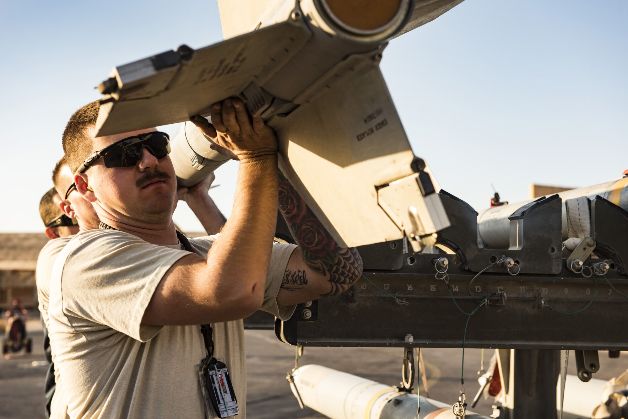 Airmen assigned to the 332d Expeditionary Maintenance Squadron work together to load munitions onto an F-15E Strike Eagle November 10, 2017 in Southwest Asia. The 332d Air Expeditionary Wing was recently awarded the 2017 Clements McMullen Memorial Daedalian Weapons System Maintenance Trophy for their crucial role in the largest air campaign in the history of Air Force Central Command. (U.S. Air Force photo by Staff Sgt. Joshua Kleinholz)
