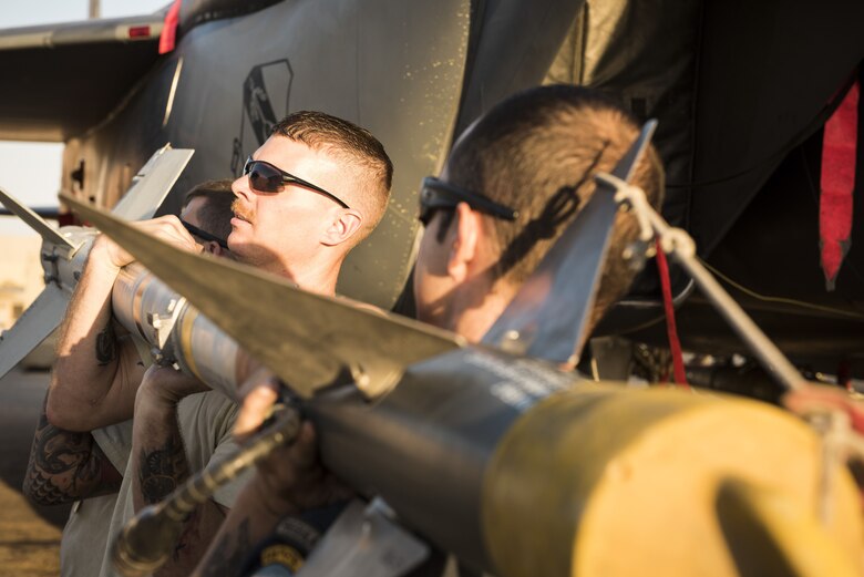 Airmen assigned to the 332d Expeditionary Maintenance Squadron work together to load munitions onto an F-15E Strike Eagle November 10, 2017 in Southwest Asia. The 332d Air Expeditionary Wing was recently awarded the 2017 Clements McMullen Memorial Daedalian Weapons System Maintenance Trophy, recognizing it as Air Combat Command’s premier large aircraft maintenance component. (U.S. Air Force photo by Staff Sgt. Joshua Kleinholz)