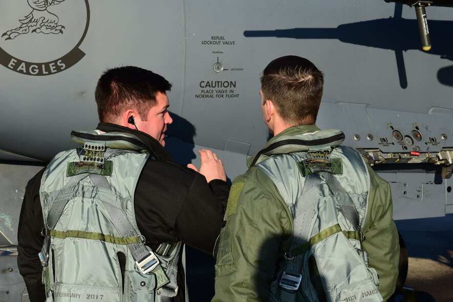 Maj. Wade Maulsby, 334th Fighter Squadron pilot, and 1st Lt. Mathew Clutts, 334th FS weapons systems operator, conduct a preflight check on an F-15E Strike Eagle, Feb. 5, 2018, at Seymour Johnson Air Force Base, North Carolina. Maulsby is the Air Combat Command nominee for the Colonel James Jabara Award for Airmanship, an award reserved for a U.S. Air Force Academy graduate whose accomplishments demonstrate superior performance in fields directly involved with aerospace vehicles. (U.S. Air Force photo by Airman 1st Class Kenneth Boyton)