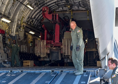 Airmen move humanitarian cargo from an Air Force transport jet in Haiti.