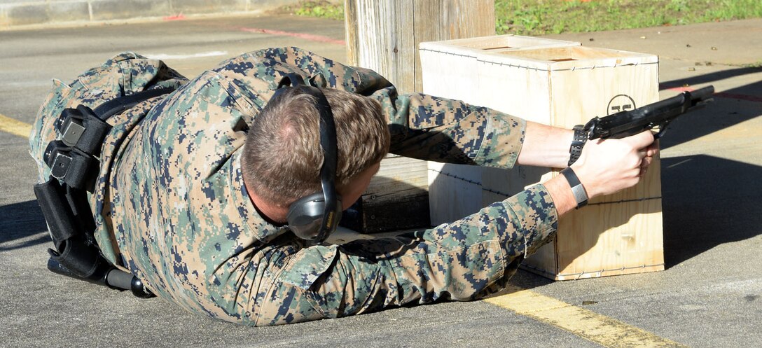 Sgt. Chad Elders, Marine Corps Community Services Marine, Marine Corps Exchange, Marine Corps Logistics Base Albany, shoots an M9 in the modified prone position during the Combat Pistol Course at MCLB Albany, Jan. 30. The course is part of the Security Augmentation Force training hosted by Marine Corps Police Department.
