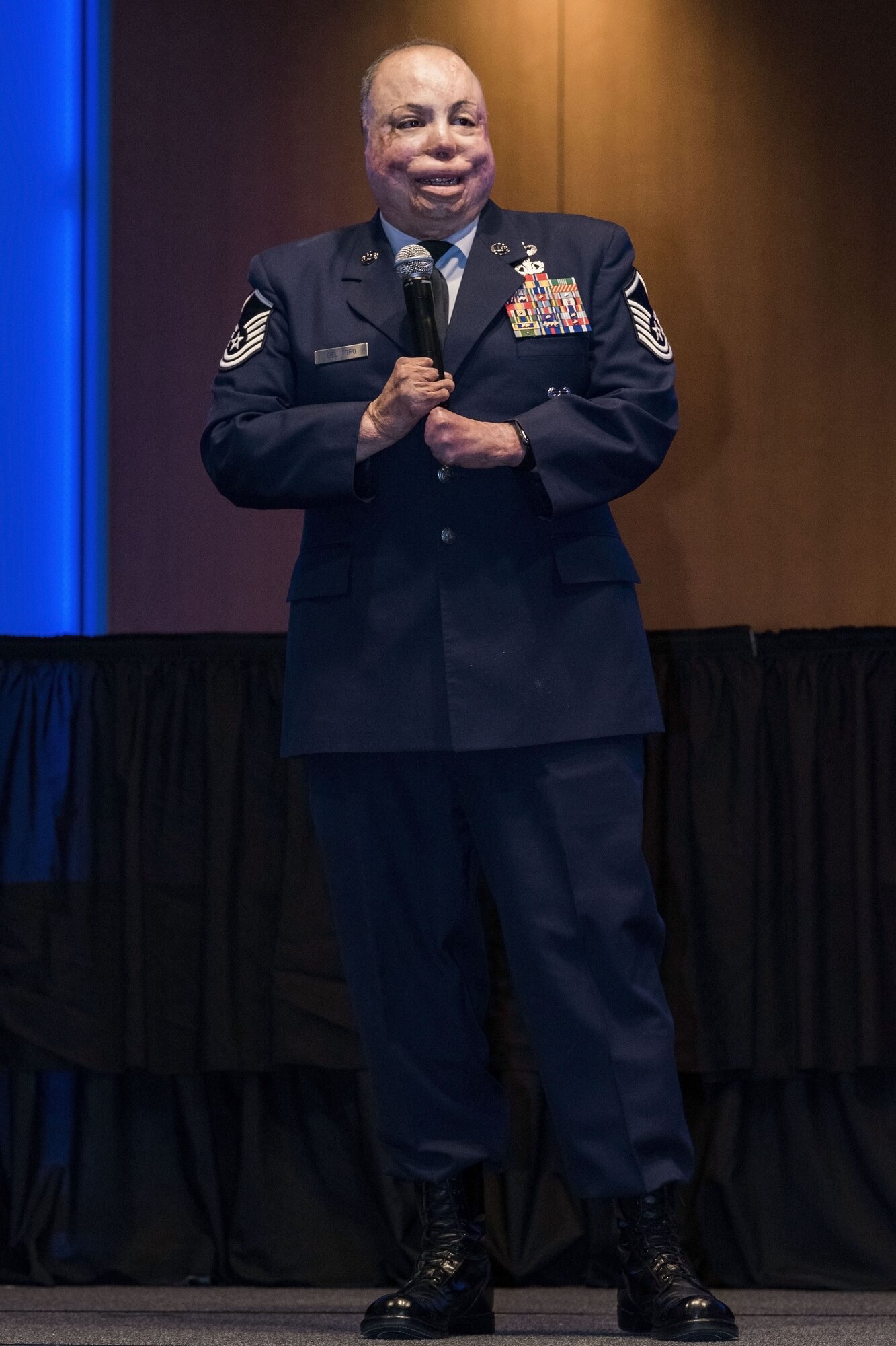 Master Sgt. Israel Del Toro Jr., United States Air Force Academy Freefall Training Program NCO in charge, Colorado Springs, Colo., speaks to more than 380 in attendance at the 436th Airlift Wing 2017 Annual Awards Ceremony Feb. 3, 2018, in the convention center at Delaware Technical Community College, Dover, Del. Del Toro, the guest speaker for the "superhero" themed ceremony, is the first 100-percent disabled Airman to re-enlist, even after undergoing more than 120 surgeries and countless hours of rehabilitation. (U.S. Air Force photo by Roland Balik)