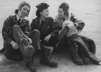 U.S. Army Air Corps 2nd Lt. Geraldine L. Curtis; 2nd Lt. Geraldine F. Dishroon, and 2nd Lt. Irene McMullen, getting into their winter flying suits for a training flight in 1943.