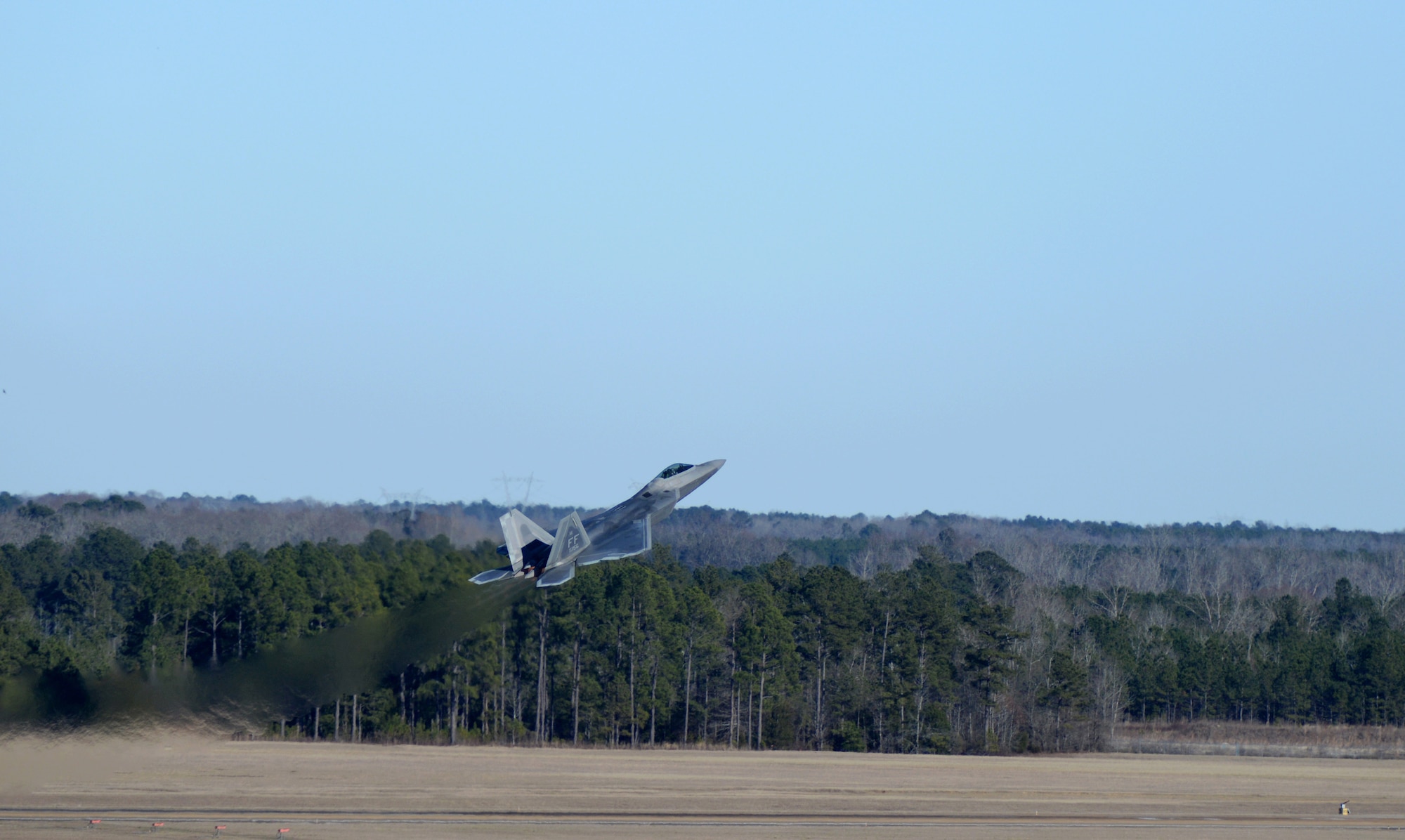 An F-22 Raptor, flown by Maj. Paul Lopez, flies over the flight line on Columbus Air Force Base, Mississippi, Feb. 2, 2018, during an aerial demonstration. The F-22 has a maximum takeoff weight of 83,000 pounds. For public demonstrations the aircraft will not carry any ammunition and will open the bomb doors to show off the array of areal capabilities the airframe has. (U.S. Air Force photo by Airman 1st Class Keith Holcomb)