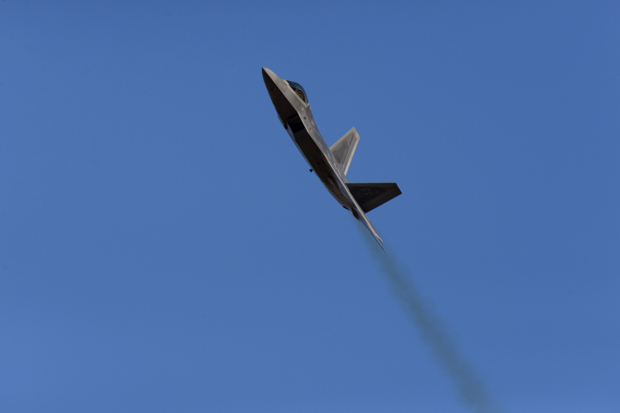 An F-22 Raptor, flown by Maj. Paul Lopez, flies over the flight line on Columbus Air Force Base, Mississippi, Feb. 2, 2018, during an aerial demonstration. The F-22 engines are extremely powerful, paired with the aerodynamic design this allows the aircraft to cruise at supersonic speeds without using afterburner. (U.S. Air Force photo by Airman 1st Class Keith Holcomb)