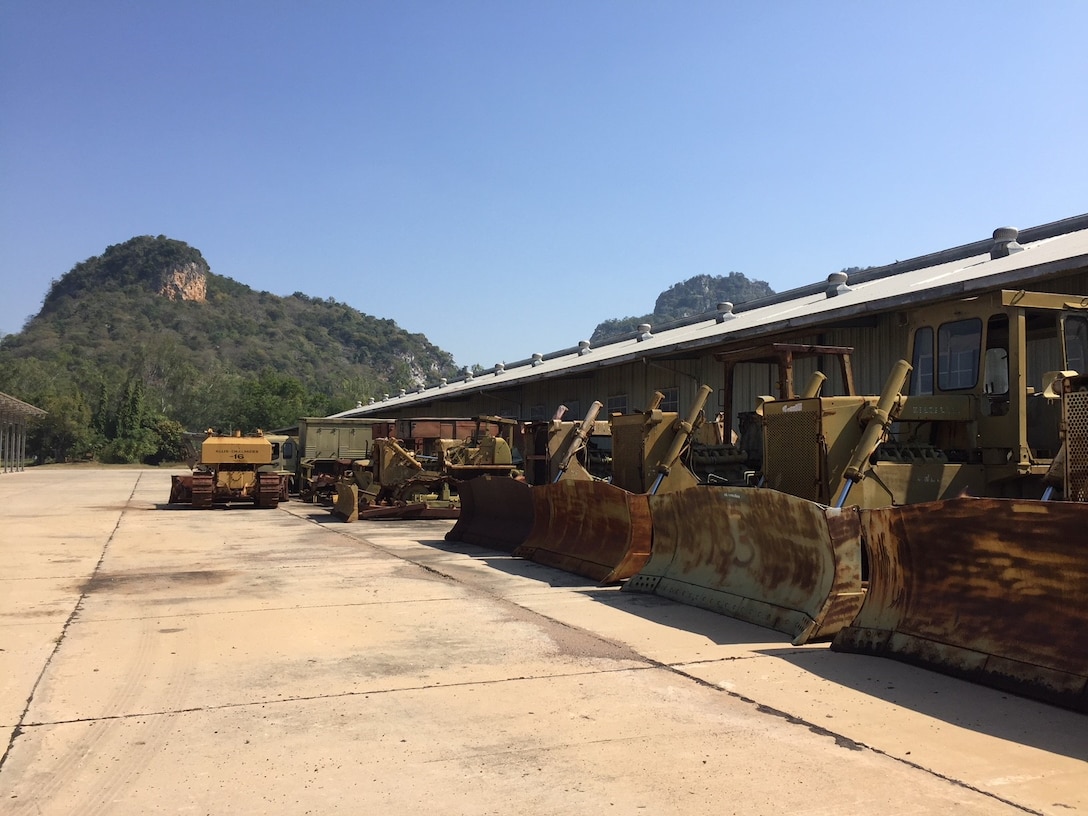 Engineering vehicles provided to Thailand for road building or maintenance works await disposal through DLA Disposition Services in Thailand.
