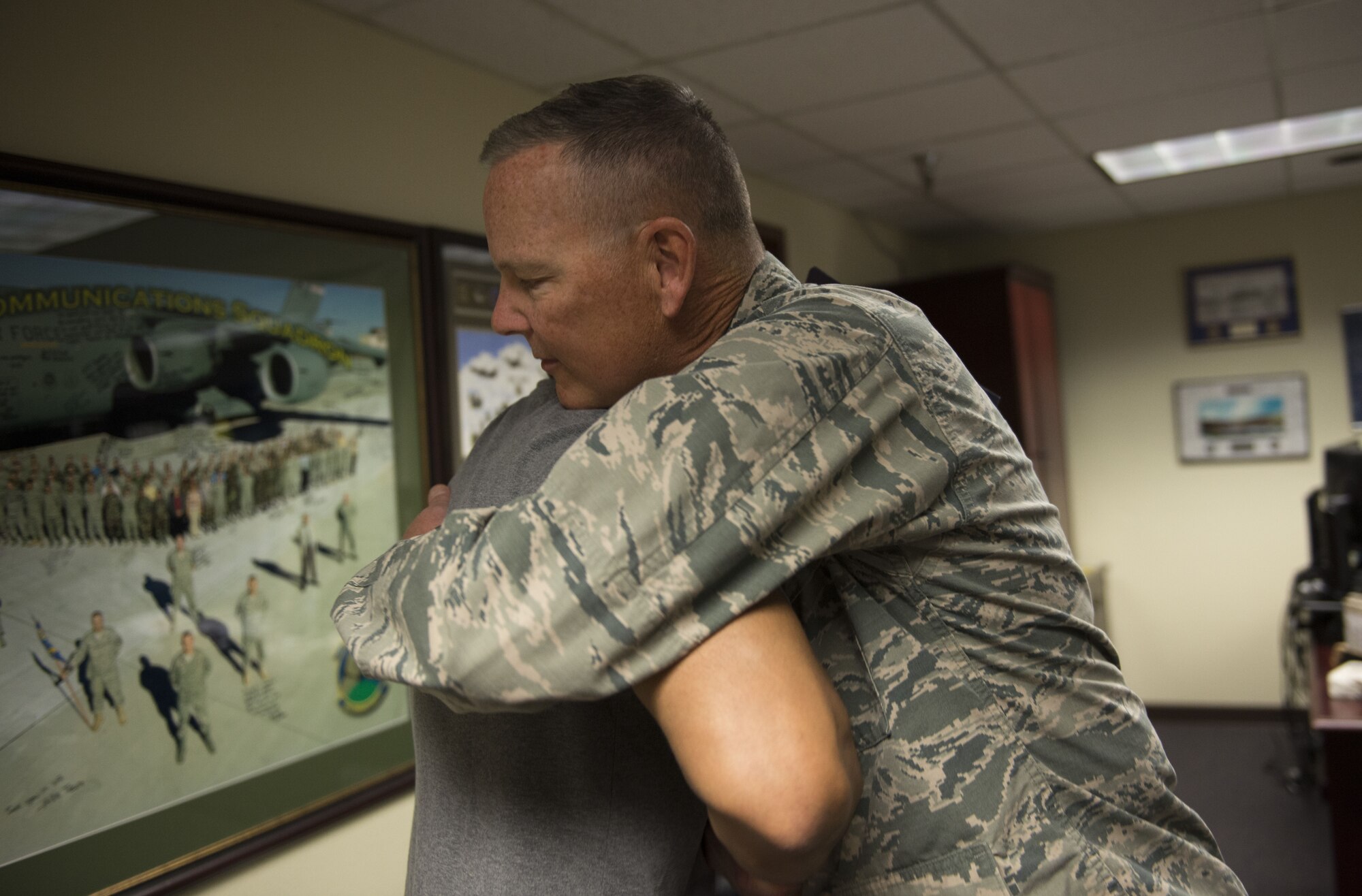Col. Robert Sylvester, 56th Mission Support Group commander, hugs Mitchell Malloy, Gold Star family member, at Luke Air Force Base, Ariz., Feb. 2, 2018. Malloy became a Gold Star family member after his father, Maj. Jeffrey Ausborn, was killed in 2011 while deployed in support of Operation Enduring Freedom. (U.S. Air Force Photo/Airman 1st Class Alexander Cook)