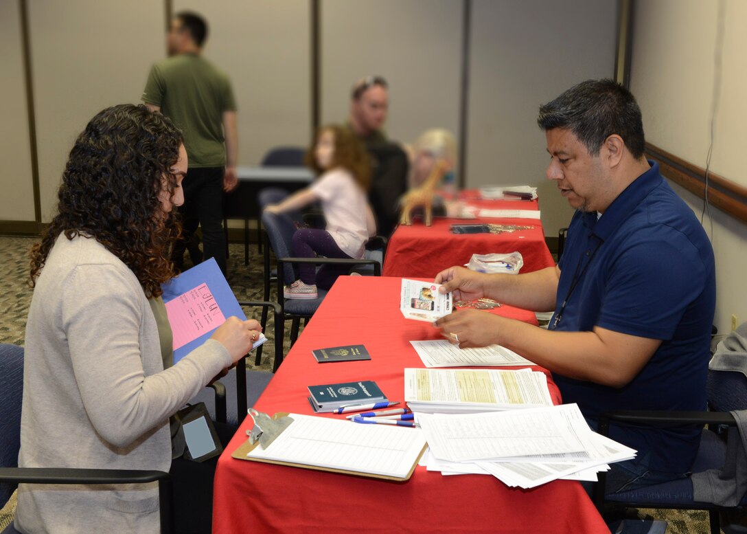 Lea Ricci, 771st Test Squadron, goes over her passport application documents with a passport specialist from the Los Angeles Passport Agency at the Airman and Family Readiness Center Feb. 6. (U.S. Air Force photo by Kenji Thuloweit)
