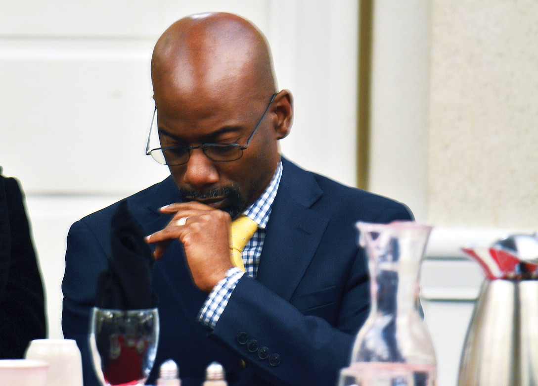 Senior Pastor Paul Graham of the Restoration Praise Center in Bowie, Maryland, was invited as the keynote speaker. Graham prays for words of wisdom before addressing guests of the 18th annual prayer breakfast at THe Clubs at Quantico.