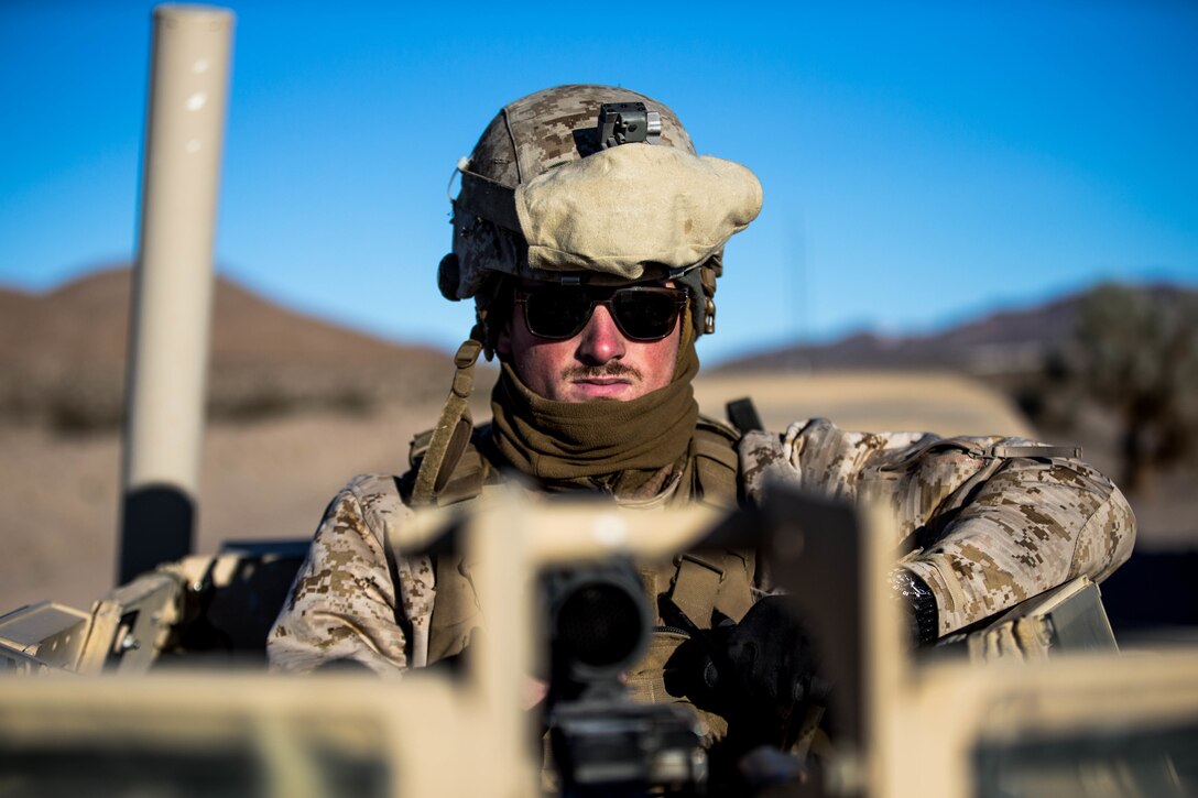 Lance Cpl. Charles Wohlers, with Marine Wing Support Squadron 371, prepares his gear for the cold wear before the Motorized Fire and Movement Exercise exercise on range 114, at Marine Corps Air Ground Combat Center, Twentynine Palms, Calif., Jan. 18, 2018, as a part of Integrated Training Exercise 2-18. The purpose of ITX is to create a challenging, realistic training environment that produces combat-ready forces capable of operating as an integrated MAGTF. (U.S. Marine Corps Photo by Pfc. William Chockey)