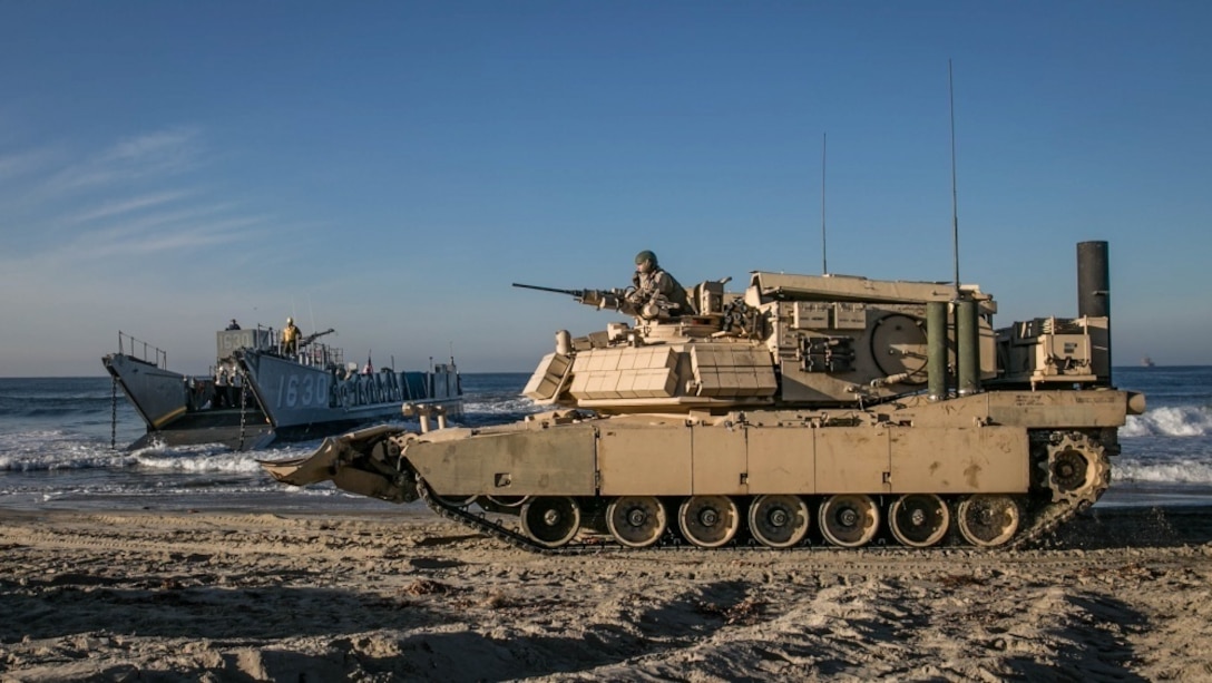 U.S. Marines from 1st Combat Engineer Battalion, 1st Marine Division, prepare to load an Assault Breacher Vehicle onto a Landing Craft Utility at Camp Pendleton, California. All vehicles were loaded onto LCUs then transported to the USS Rushmore to conduct the first amphibious landing in an ABV with a Modified Full Width Mine Plow prototype. Marine Corps Systems Command tested the prototype which will make it easier to transport the ABV from ship to shore.