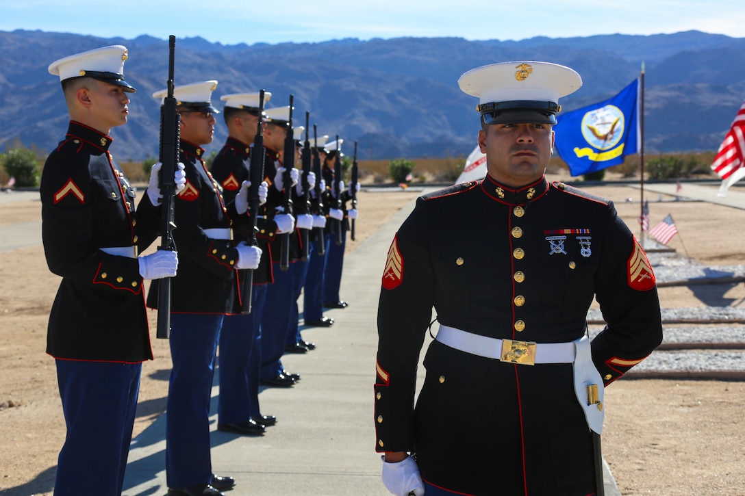 Sgt. Rafael Fernandez, SPINTCOMM Operator, Headquarters Battalion, Marine Corps Air Ground Combat Center, Twentynine Palms, Calif., commands a rifle squad during the funeral ceremony of Ray V. Wilburn, retired Sgt. Major, at Twentynine Palms Public Cemetery, Jan. 13, 2018. Wilburn served 32 years of honorable and faithful service to the United States Marine Corps, taking part in World War 2, the Korean War and the Vietnam War. (U.S. Marine Corps photo by Lance Cpl. Isaac Cantrell)