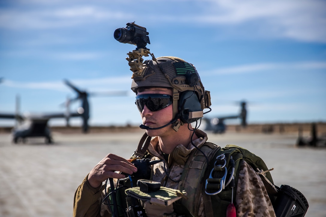 A Marine with 3rd Reconnaissance Battalion, 3rd Marine Division, 3rd Marine Expeditionary Force waits to board a MV-22 Osprey at the Air Combat Element landing strip at Marine Corps Air Ground Combat Center, Twentynine Palms, Calif., Jan. 18, 2018, as a part of Integrated Training Exercise 2-18. The purpose of ITX is to create a challenging, realistic training environment that produces combat-ready forces capable of operating as an integrated MAGTF. (U.S. Marine Corps Photo by Pfc. William Chockey)