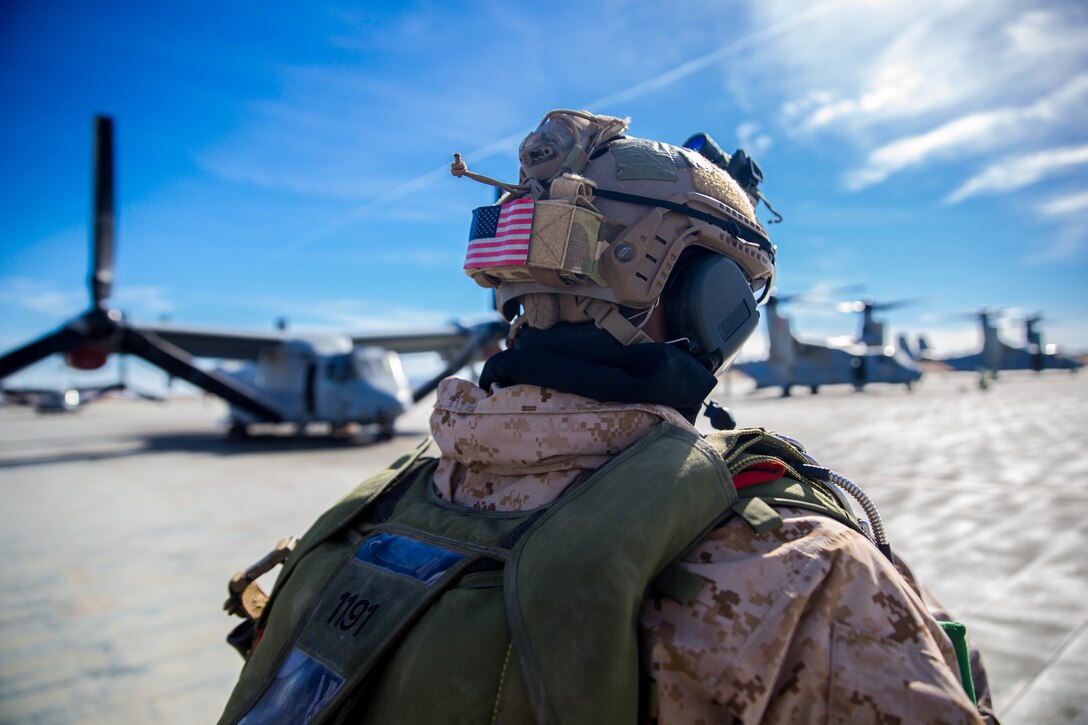A Marine with 3rd Reconnaissance Battalion, 3rd Marine Division, 3rd Marine Expeditionary Force walks past MV-22 Osprey’s at the Air Combat Element landing strip at Marine Corps Air Ground Combat Center, Twentynine Palms, Calif., Jan. 18, 2018, as a part of Integrated Training Exercise 2-18. The purpose of ITX is to create a challenging, realistic training environment that produces combat-ready forces capable of operating as an integrated MAGTF. (U.S. Marine Corps Photo by Pfc. William Chockey)