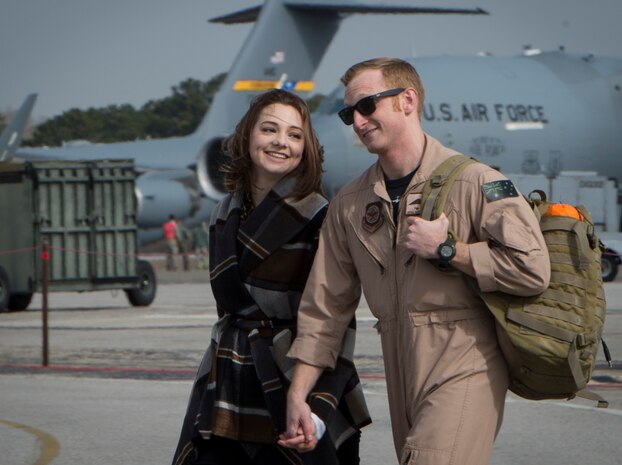 Royal Australian air force Flight Lt. Timothy Burnard, assigned to the 15th Airlift Squadron walks on the flightline with his significant other, Amanda Robinson, after returning to Joint Base Charleston, S.C., Feb. 3, 2018, from a Southwest Asia deployment.