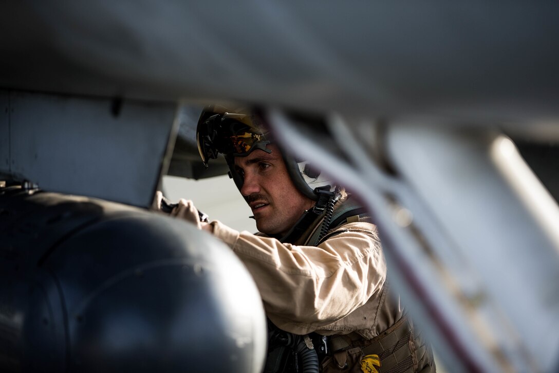 A Marine with Marine Fighter Attack Squadron All-Weather 225 does a pre-flight check of a F-18 at the Air Combat Element landing strip aboard the Marine Corps Air Ground Combat Center, Twentynine Palms, Calif., Jan. 26, 2018, as a part of Integrated Training Exercise 2-18. The purpose of ITX is to create a challenging, realistic training environment that produces combat-ready forces capable of operating as an integrated MAGTF. (U.S. Marine Corps Photo by Pfc. William Chockey)