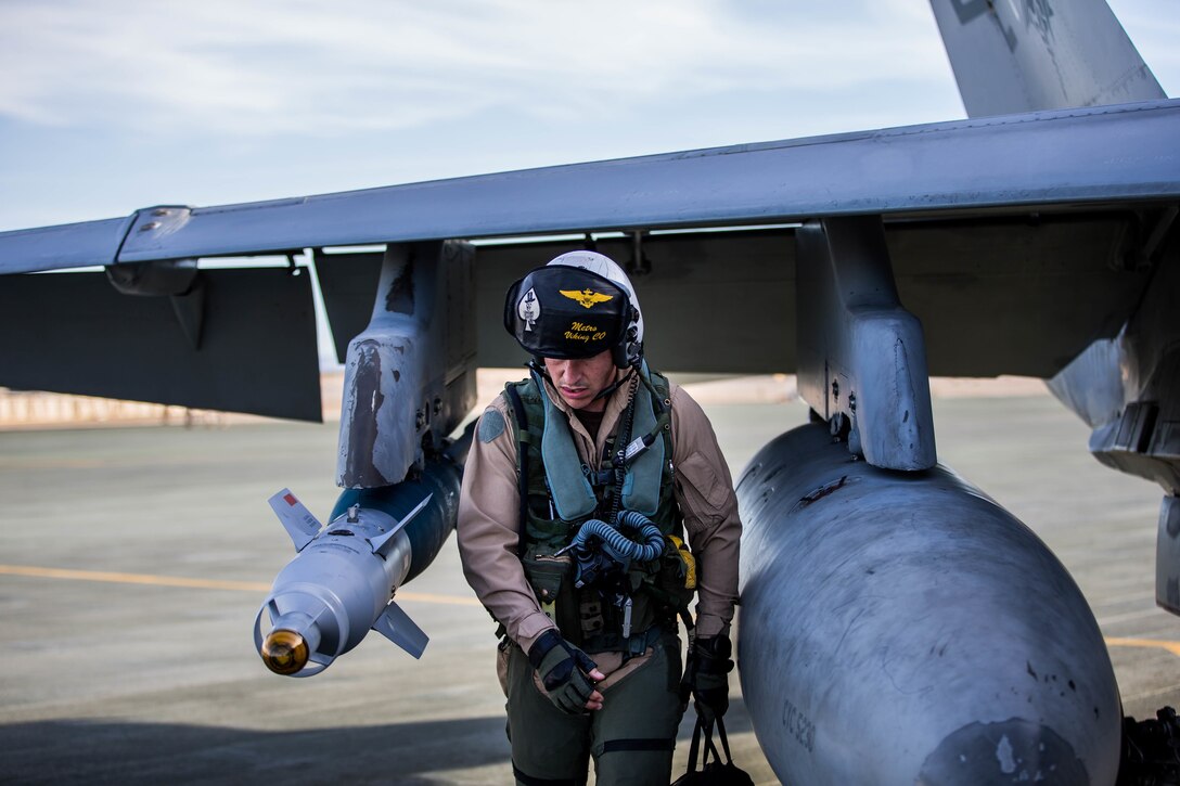 A Marine with Marine Fighter Attack Squadron All-Weather 225 does a pre-flight check of a F-18 at the Air Combat Element landing strip aboard the Marine Corps Air Ground Combat Center, Twentynine Palms, Calif., Jan. 26, 2018, as a part of Integrated Training Exercise 2-18. The purpose of ITX is to create a challenging, realistic training environment that produces combat-ready forces capable of operating as an integrated MAGTF. (U.S. Marine Corps Photo by Pfc. William Chockey)