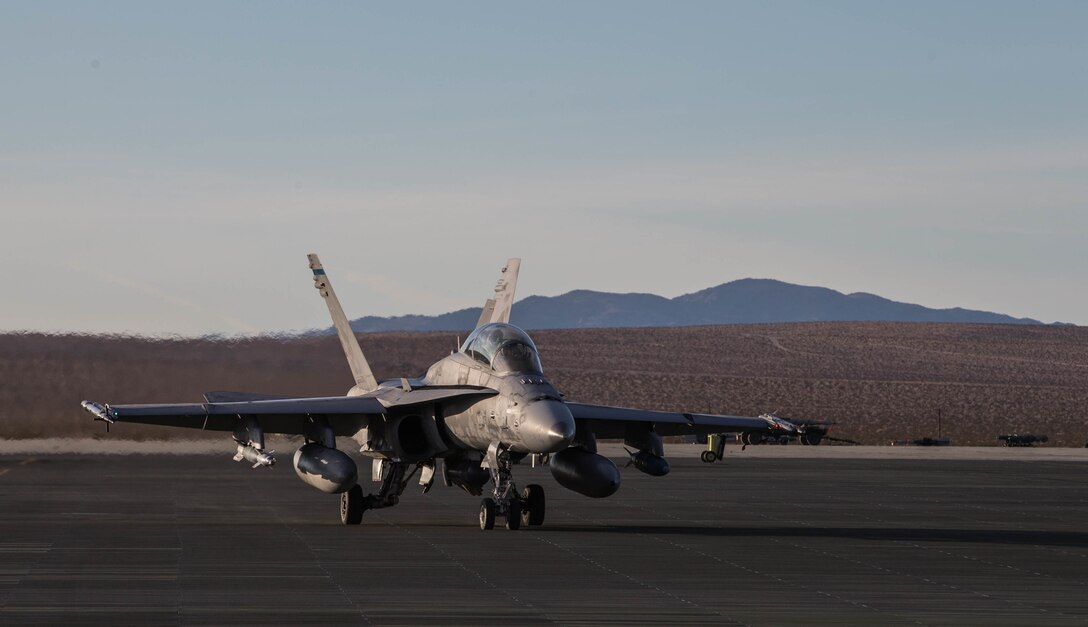 Marines with Marine fight Attack Squadron All-Weather 225 get ready for takeoff at the Air Combat Element landing strip at Marine Corps Air Ground Combat Center, Twentynine Palms, Calif., Jan. 26, 2018, as a part of Integrated Training Exercise 2-18. The purpose of ITX is to create a challenging, realistic training environment that produces combat-ready forces capable of operating as an integrated MAGTF. (U.S. Marine Corps Photo by Pfc. William Chockey)