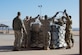 Soldiers from the U.S. Army Reserve 561st Regional Support Group, spread netting over a baggage pallet during a cargo preparation course at Offutt Air Force Base, Nebraska, Jan. 29, 2018. The Soldiers gained knowledge and skill in palletization, rolling stock, weighing, ways to protect and secure stock and the hazards to be aware of while working with air cargo. (U.S. Air Force photo by Senior Airman Jacob Skovo)