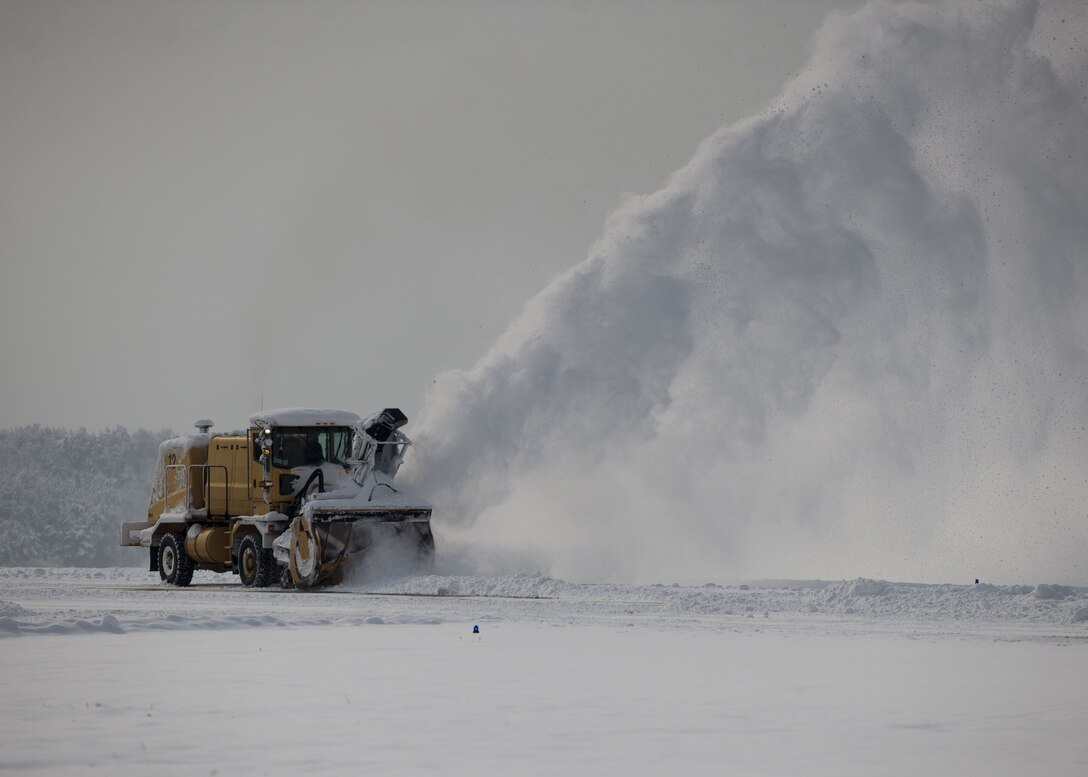 An Airman assigned to the 8th Civil Engineer Squadron operates a snow plow to clear the runway at Kunsan Air Base, Republic of Korea, Jan. 11, 2018 and ensure the continuation of flight operations. During the second week of January more snow accumulated at Kunsan than in all of 2017, requiring snow removal teams to conduct 24-hour operations to maintain mission readiness. (U.S. Air Force photo by Staff Sgt. Victoria H. Taylor)