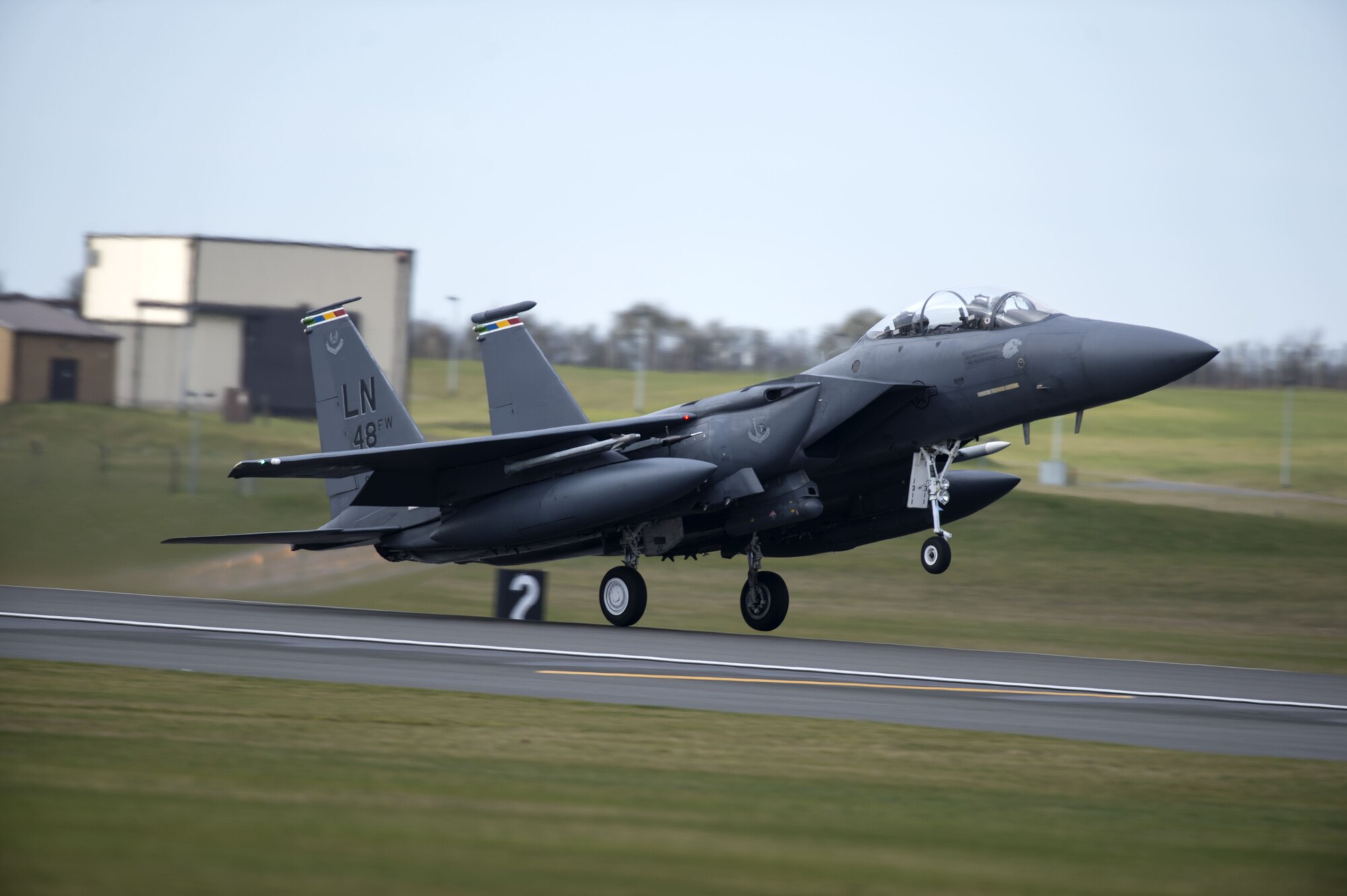 An F-15E Strike Eagle flying the colors of multiple 48th Fighter Wing squadrons takes off from Royal Air Force Lakenheath, England, Feb. 6, 2018. The array of colors identifies it as the 48th FW commander’s aircraft.  An array of avionics and electronics systems gives the F-15E the capability to fight at low altitude, day or night, and in all weather. (U.S. Air Force photo/Senior Airman Malcolm Mayfield)