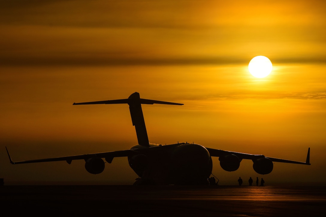 Airmen load equipment onto a C-17 Globemaster III aircraft.