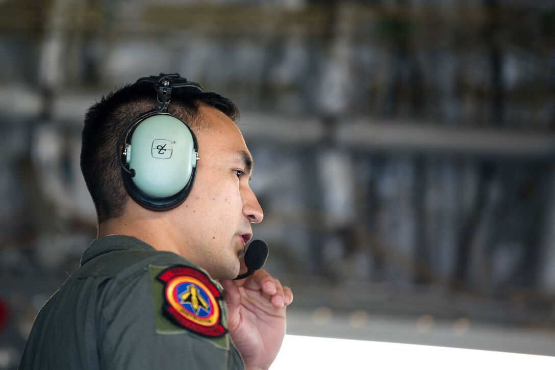 Air Force Staff Sgt. Richard Prokop gives a safety briefing to airmen aboard a C-17 Globemaster III aircraft.