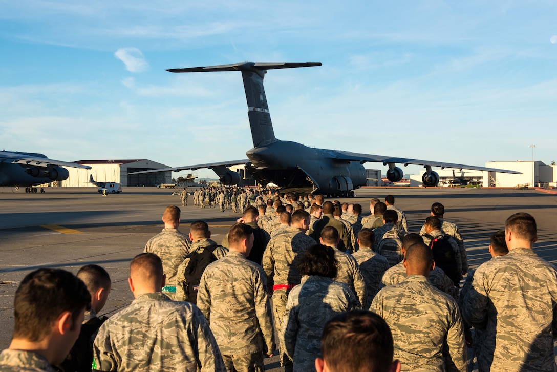 Airmen prepare to board a C-5 Super Galaxy aircraft.