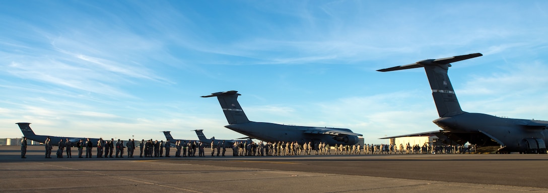 Airmen board a C-5 Super Galaxy aircraft during a readiness exercise.