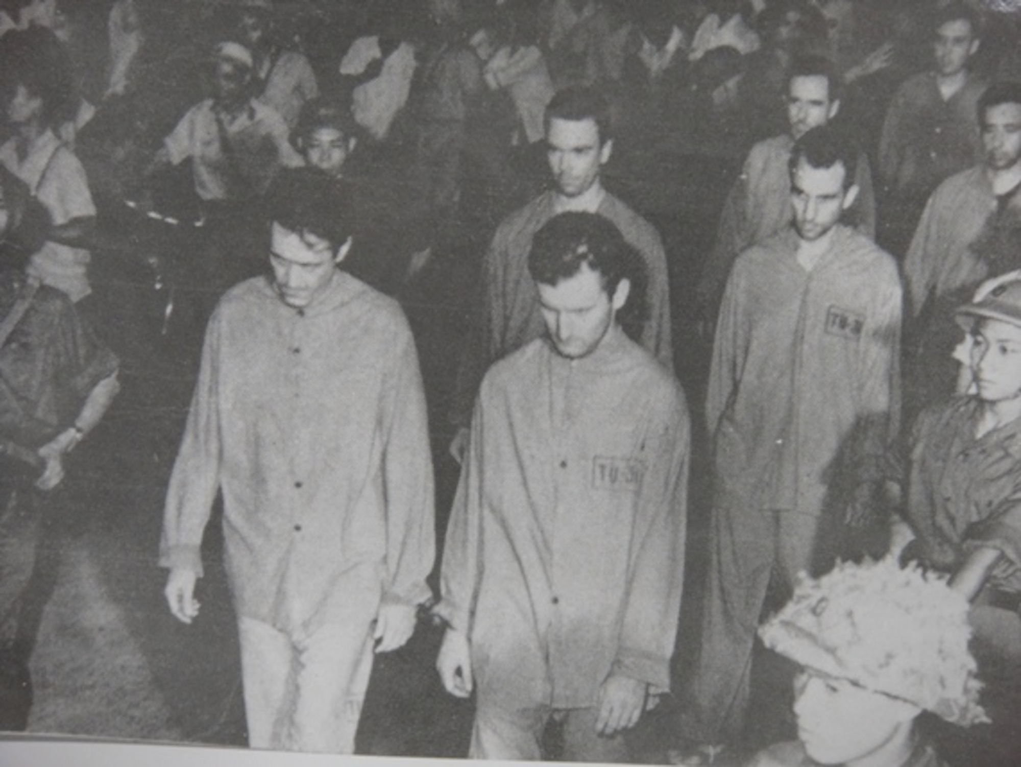 Prisoners of war are marched in a Vietnamese prison camp during the Vietnam War. One prisoner, retired Col. Carlyle “Smitty” Harris was shot down April 4, 1965, during a bombing run targeting the Thanh Hoa Bridge. (Courtesy photo)