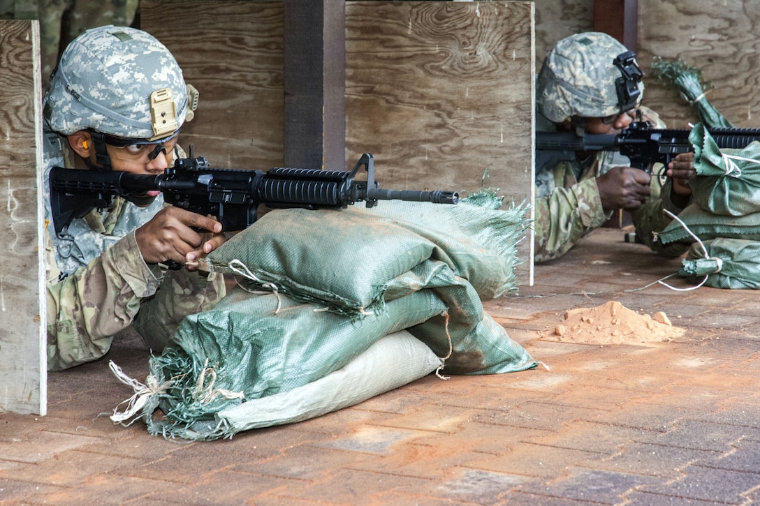 Soldiers fire their rifles on a range.