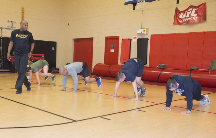 Marines from U.S. Marine Corps Forces Command and Marine Air Group 49, Marine Medium Tiltrotor Squadron 774, 4th Marine Aircraft Wing, do burpees while Christopher Harper, High Intensity Tactical Training coordinator, Semper Fit, monitors their technique during a HITT Level I instructor course  at Hopkins Hall Gym, aboard Camp Allen, in Norfolk, Va., Feb. 6. Marines split  time between classroom lecture and practical application, learning about functional 
exercises, nutrition and stability.
"HITT and the Combat Fitness Test have a lot of similar elements," said Harper. "These include speed, agility, muscular endurance and power." (Official Marine Corps photo by Chris Jones/Released)