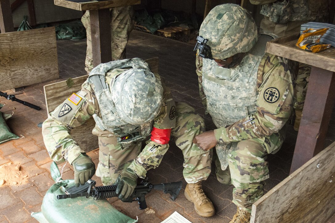 A soldier gets instruction while practice shooting